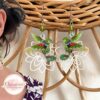 Boucles d'oreilles colibris verts sur fleurs blanches résine laiton acier inoxydable perles par Odacassie